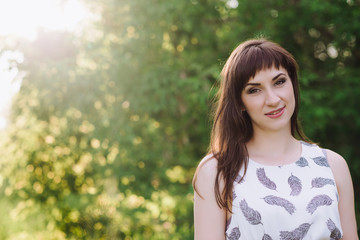 Fototapeta premium Beautiful Young Woman Outdoors. Enjoy Nature. Healthy Smiling Girl in Green Grass.