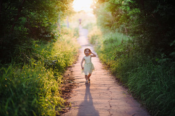 Outdoor portrait of a cute little girl playing in the grass, childhood, happiness, nature, relaxation