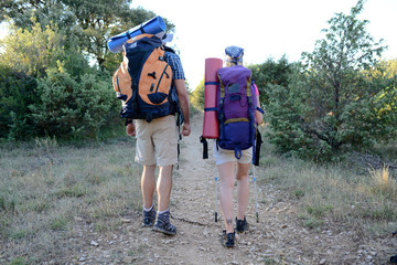 Fototapeta na wymiar young couple hiking together with backpack on an adventure trek