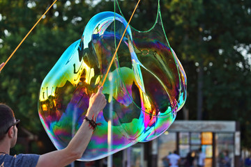 the man let a big bubble in the street
