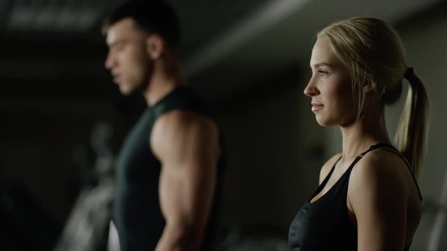 young woman and man doing a fitness workout with dumbbells