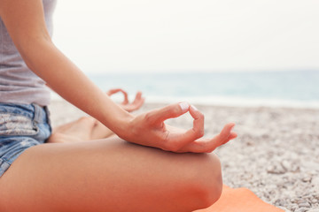 Meditating. Woman doing yoga. Close-up