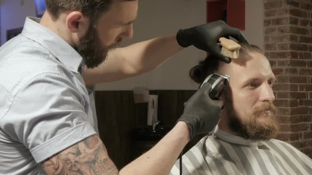 men's hairstyling and haircutting with hair clipper in a barber shop or hair salon