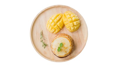 pancake and mango on dish, isolated on white background