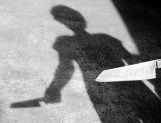 Shadow man raised a knife to stab