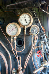 Pressure gauges on old steam train - 114396437