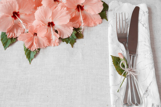 Pink Hibiscus flowers table setting background, toning