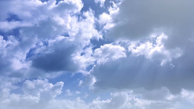 FullHD video - Timelapse video of playful, fluffy, gray and white clouds, forming, building and drifting in the wind with rays of sunlight shining through.