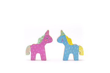 Wooden colorful unicorn horses on white background