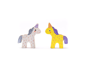 Wooden colorful unicorn horses on white background
