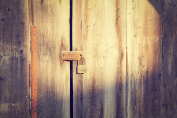 Old wooden door which has old lock at old town : Songkhla province Thailand (vintage style)
