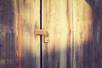 Old wooden door which has old lock at old town : Songkhla province Thailand (vintage style)
