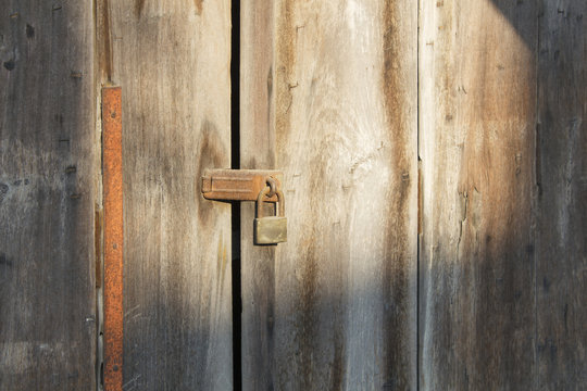 Old wooden door which has old lock at old town : Songkhla province Thailand
