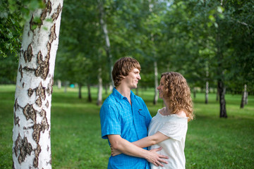 Fototapeta premium Portrait of a happy loving couple outdoor in the green park