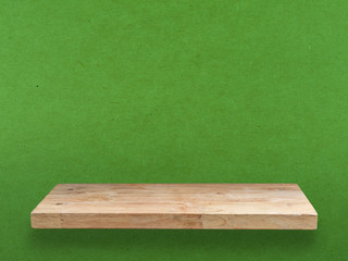 wooden shelf on green background