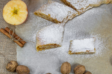 Detail on a Sugared Homemade Apple Strudel on a Baking Paper Top