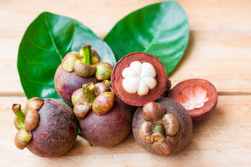 the Mangosteen on rustic wooden table. Local fruit of Thailand