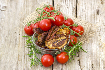 fresh and dried tomatoes on wooden background