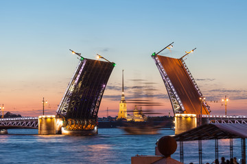 Fototapeta na wymiar Defocused sailboat under the Palace bridge at night. Saint Petersburg