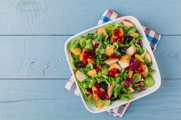 Fresh French salad with baked camembert, cranberries and fresh f