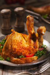 Baked chicken leg, served with roasted potatoes and vegetables.