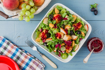 Fresh French salad with baked camembert, cranberries and fresh f