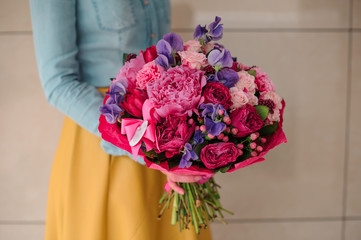 girl holding bouquet of a mixed pink and purple flowers