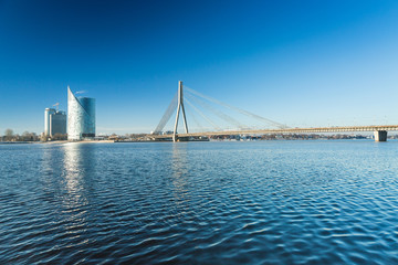 A view of the buildings and Vansu bridge on the banks of the Daugava River in Riga, Latvia