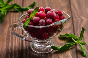 Frozen cranberries in a glass bowl 