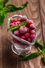 Frozen cranberries in a glass bowl 