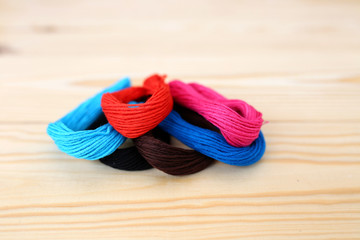 Colored threads on wooden background. Sewing kit. Set for needlework