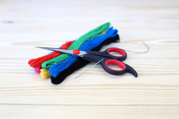 Colored threads on wooden background. Sewing kit. Set for needlework