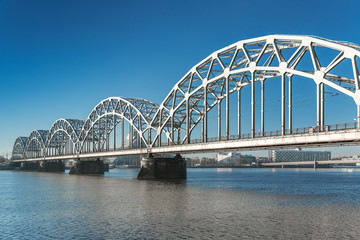 Obraz na płótnie Canvas A view of the Railway Bridge over Daugava River in Riga, Latvia