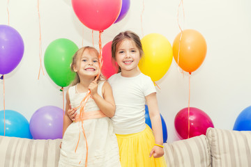 Fototapeta na wymiar Two little girls at a birthday party