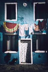 Clothesline in front of Blue House, Burano, Italy - obrazy, fototapety, plakaty