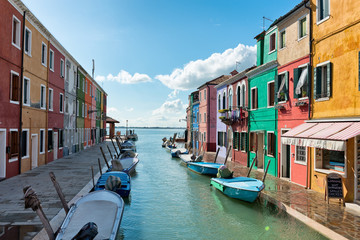 Fototapeta na wymiar Colorful canal Burano, Venice, going to the lagoon