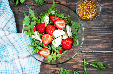 Salad of lettuce, arugula, strawberries, feta cheese