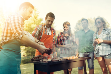 Friends having a barbecue party in nature