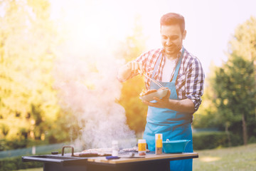 Handsome man preparing barbecue