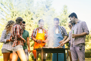 Young people grilling outdoors