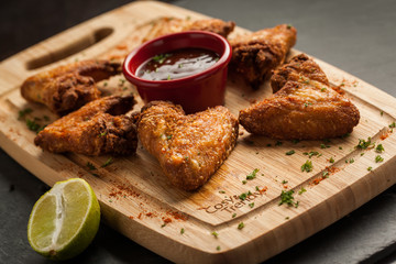 Tex mex fried chicken wings on a wooden cutting board