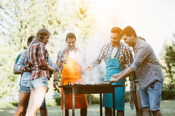 Young people grilling outdoors