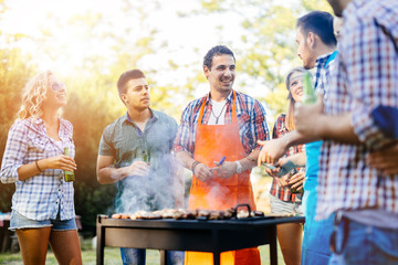 Young people grilling outdoors