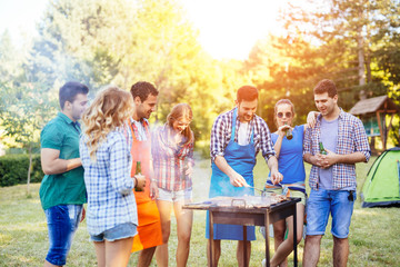Friends having a barbecue party in nature