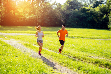 Athletic couple jogging in nature