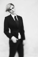 Short hair woman in a suit pose stylish