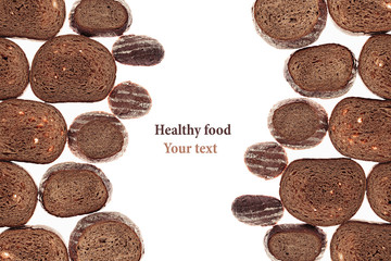 Decorative edging pieces of black rye bread on a white background. Isolated. Border. Pattern. Food background. View from above.