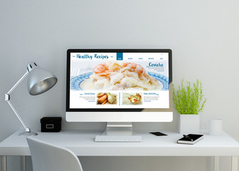 modern clean workspace with healthy recipes website on screen