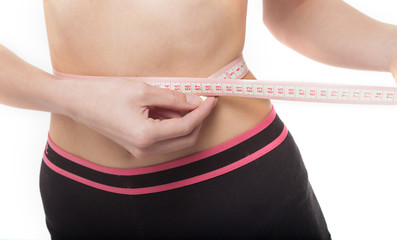 Woman measuring her slim body on white background