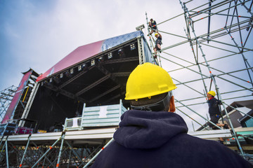 building entertainment stage for music festival wearing safety c - obrazy, fototapety, plakaty